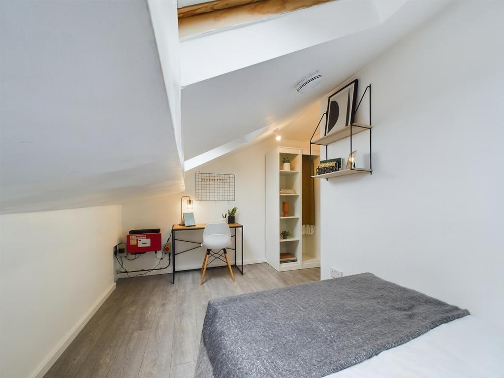 A bright and neatly maintained bedroom with a c...
