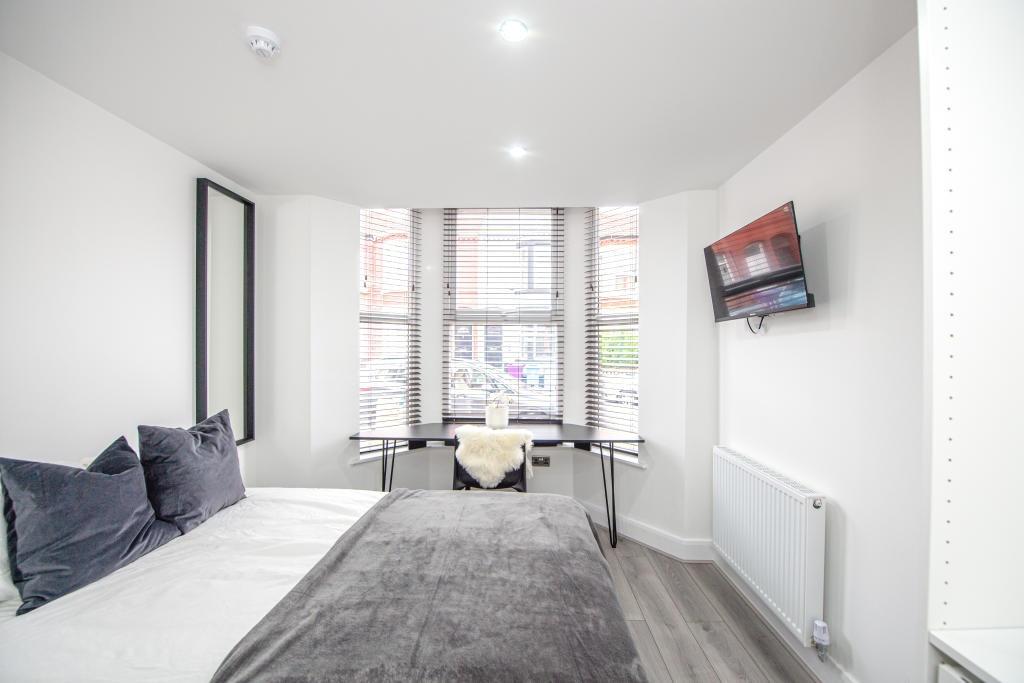 Bright and modern living room with ample natura...