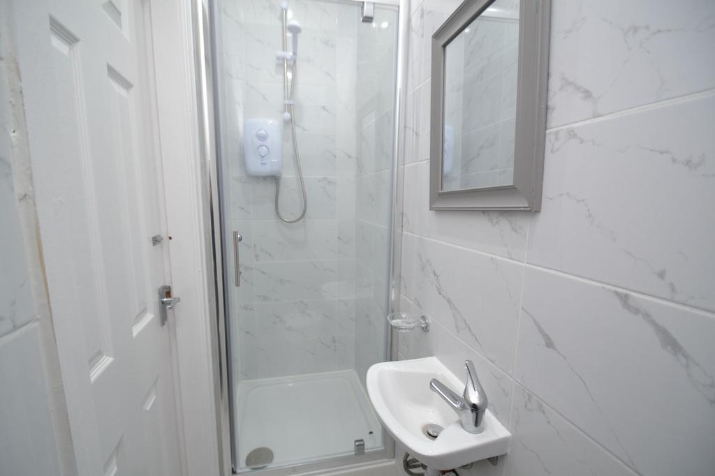 Well-maintained bathroom featuring a shower wit...