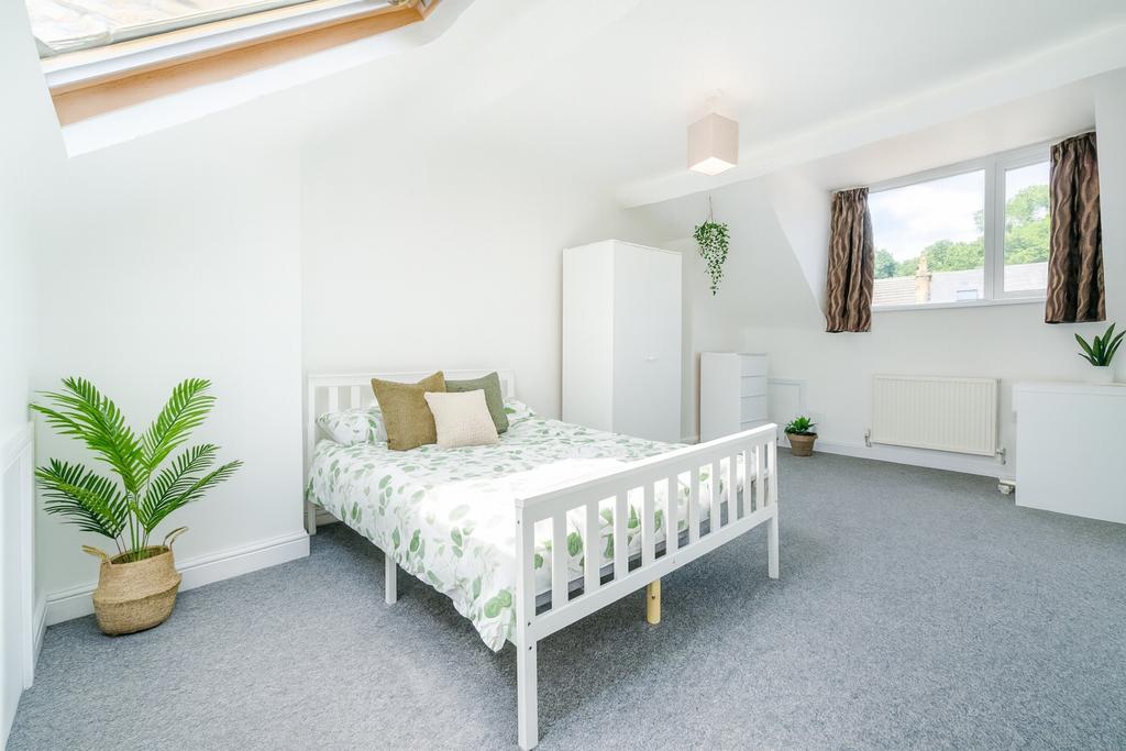 Bright and airy bedroom featuring a cozy double...