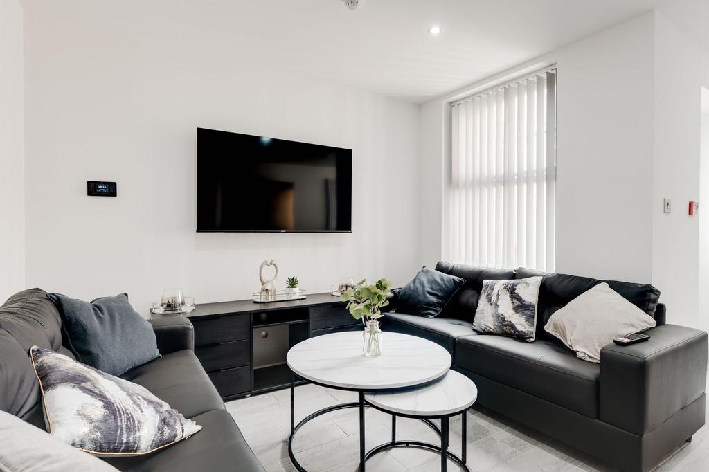 A modern, well-lit living room featuring two bl...