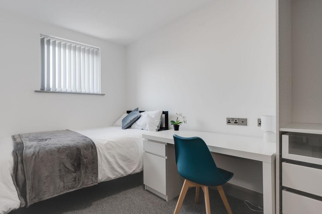 Bright and minimalist single bedroom featuring ...
