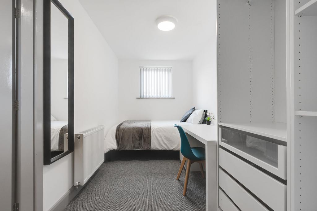 A bright, modern bedroom featuring a large bed ...