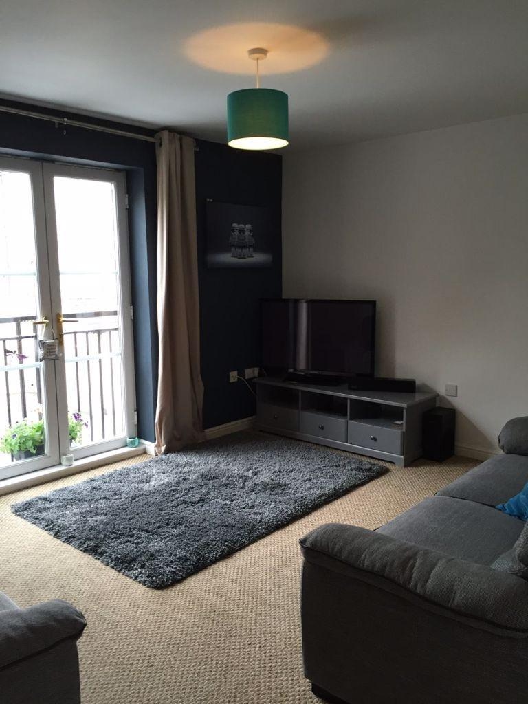 Bright, neatly presented living room with balco...