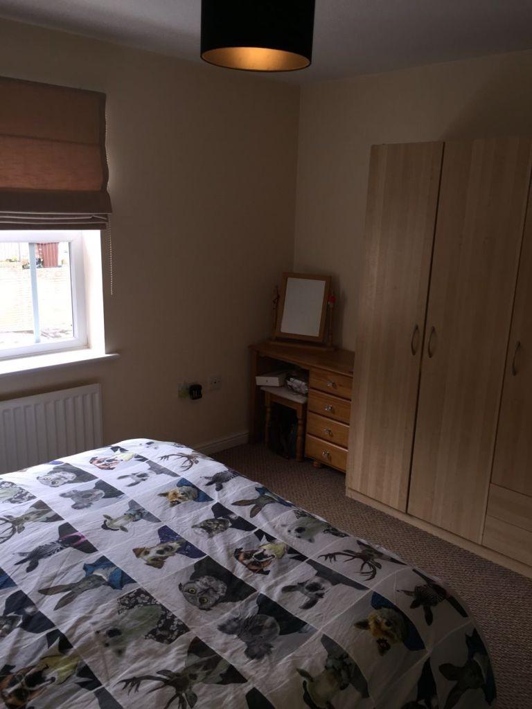 Neat double bedroom with a patterned duvet, fit...