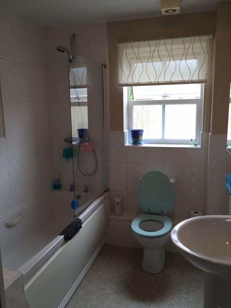Neat three-piece bathroom with a bathtub and ov...