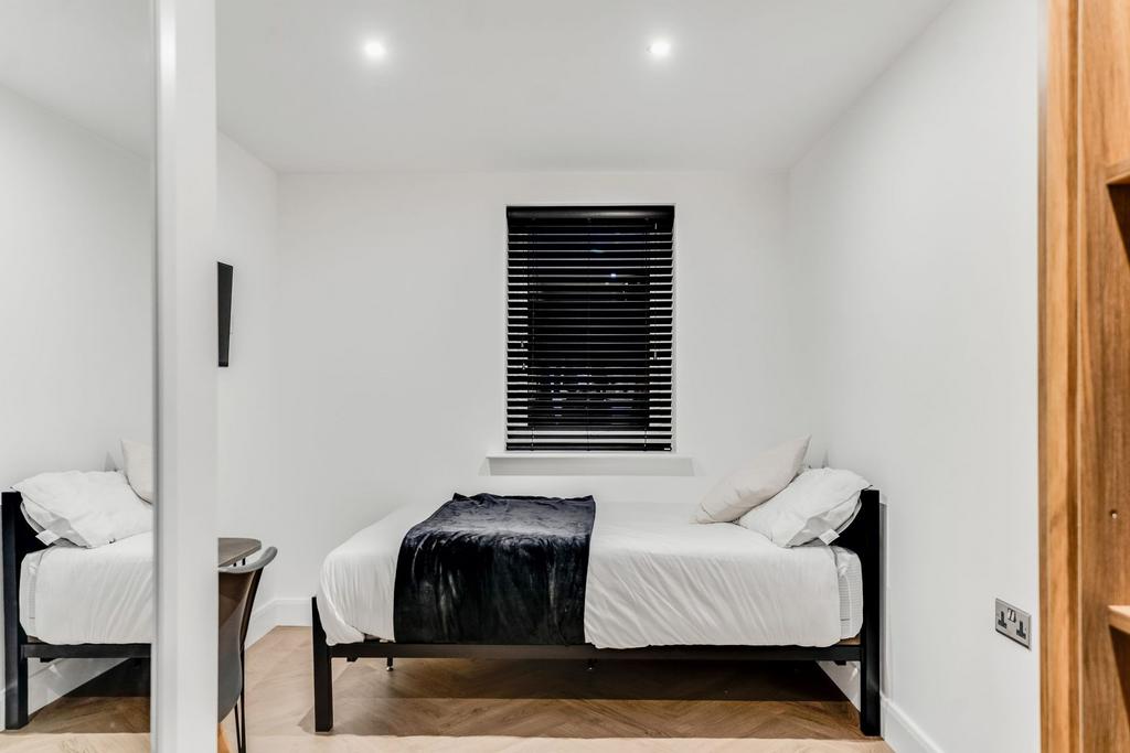 A tidy double bedroom featuring a comfortable b...