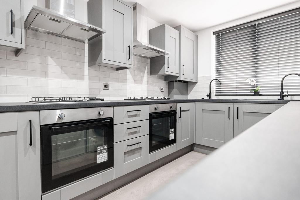 Modern and well-maintained kitchen featuring sl...