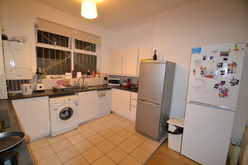 Spacious and well-equipped kitchen featuring mo...