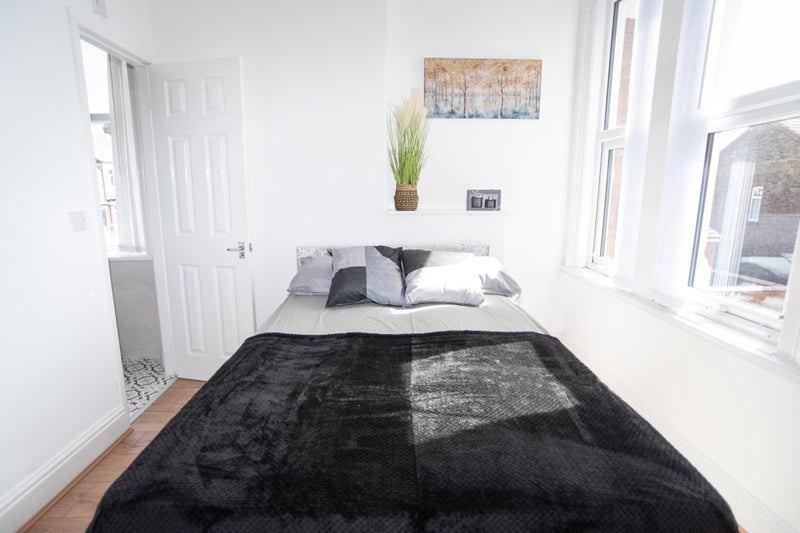 Bright, neatly presented bedroom with a double ...