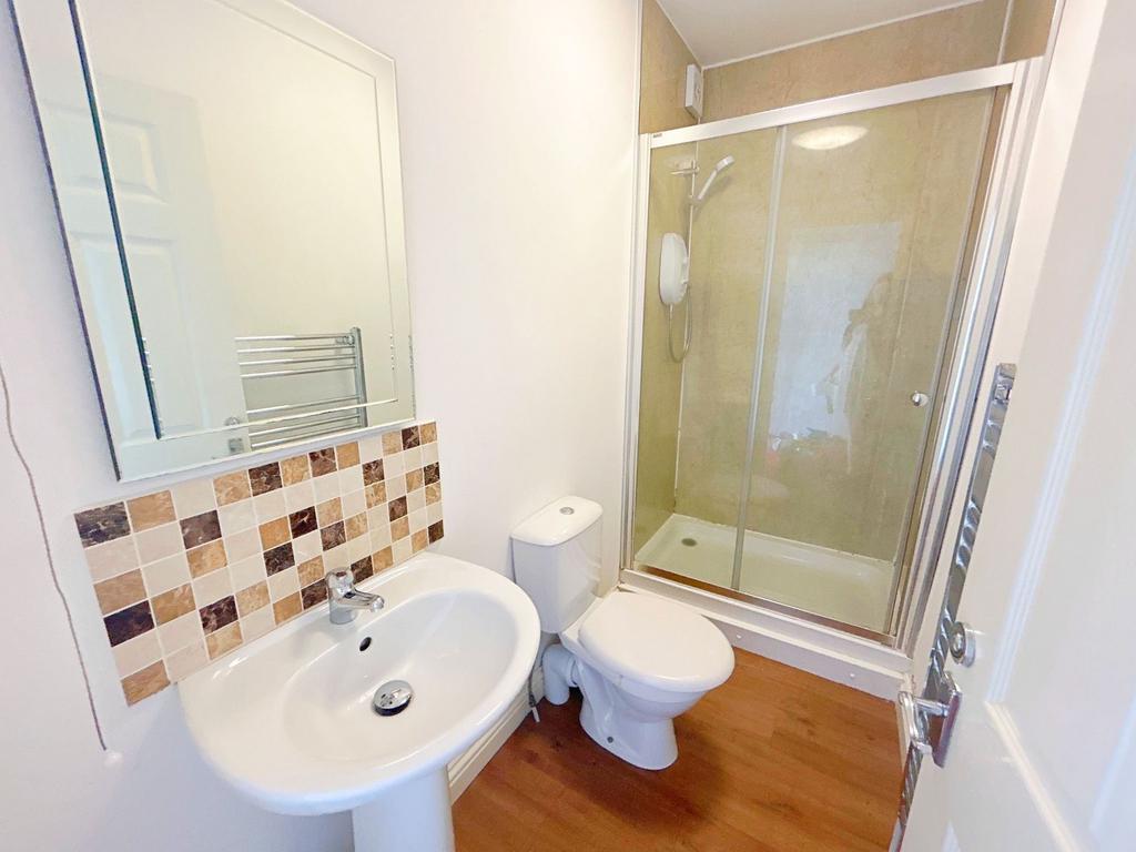 Bright and tidy bathroom featuring a modern sho...