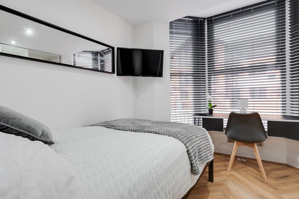 A modern, well-maintained bedroom with ample na...