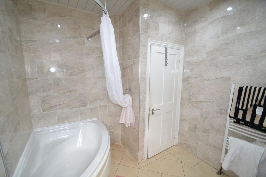 A clean, well-maintained bathroom featuring bei...