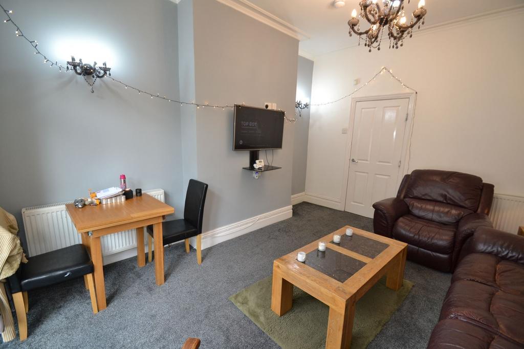 A cozy, well-lit living room featuring comforta...