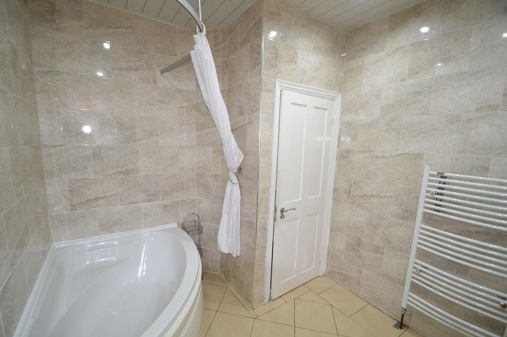 Bright and modern bathroom featuring elegant be...