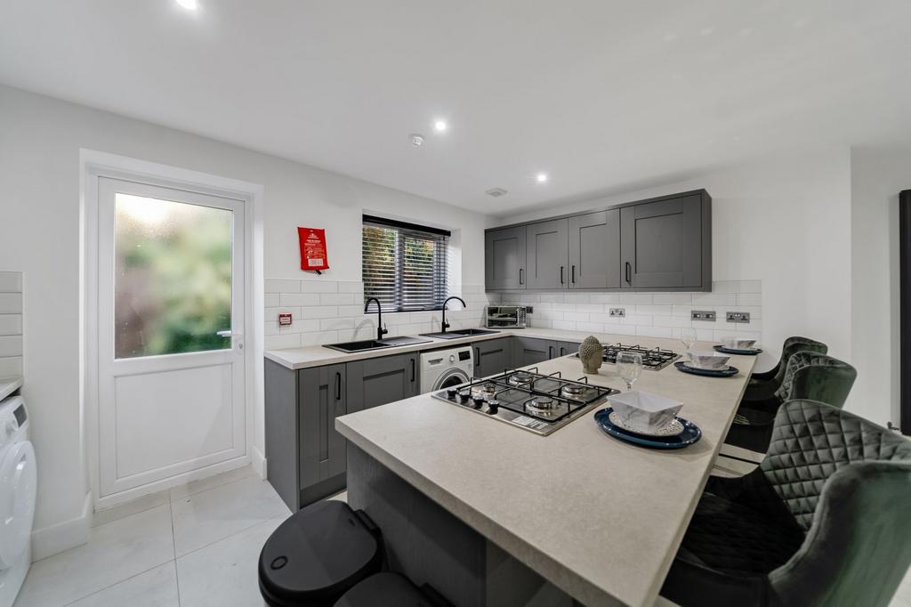 Modern and well-maintained kitchen featuring sl...