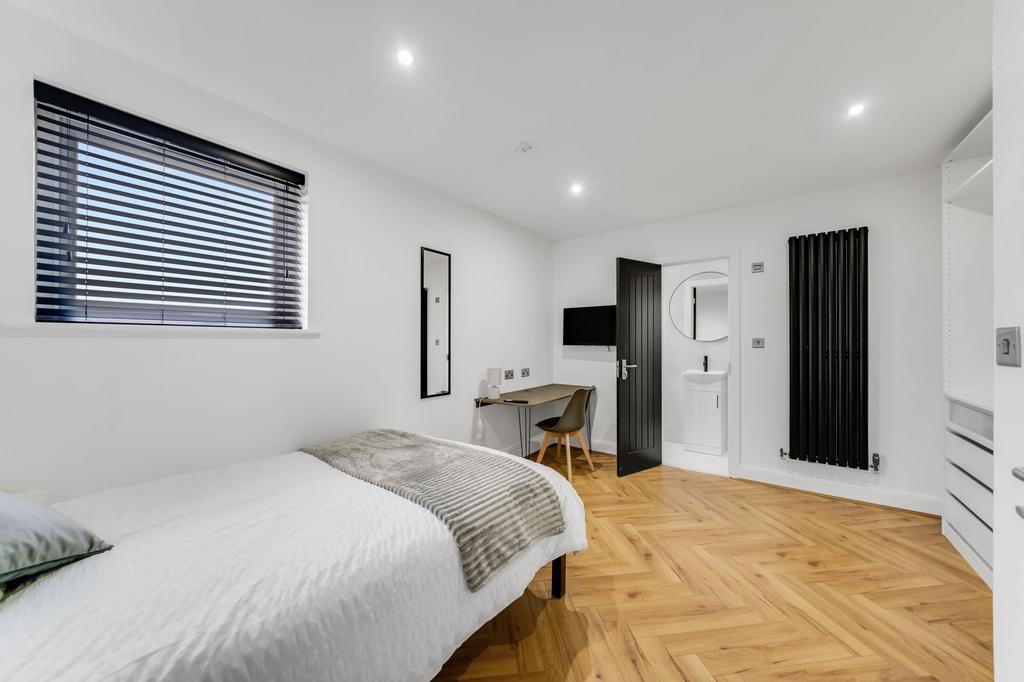 A modern, bright bedroom featuring a comfortabl...