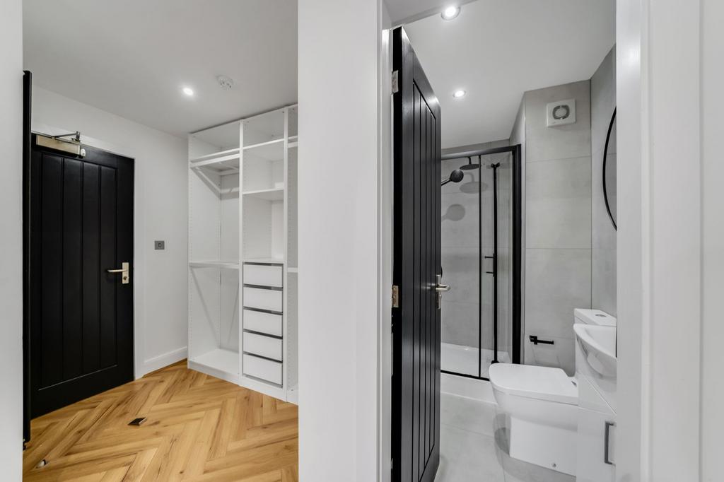 Modern bathroom featuring a spacious shower are...