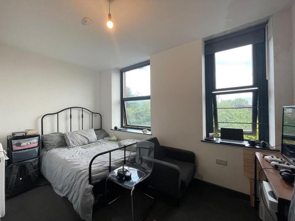Bright and well-maintained bedroom featuring la...