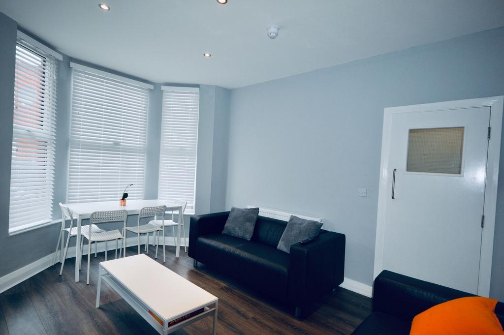 Bright and spacious living room featuring large...