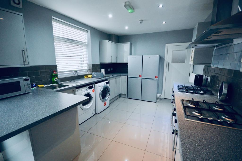 A modern, well-maintained kitchen featuring whi...