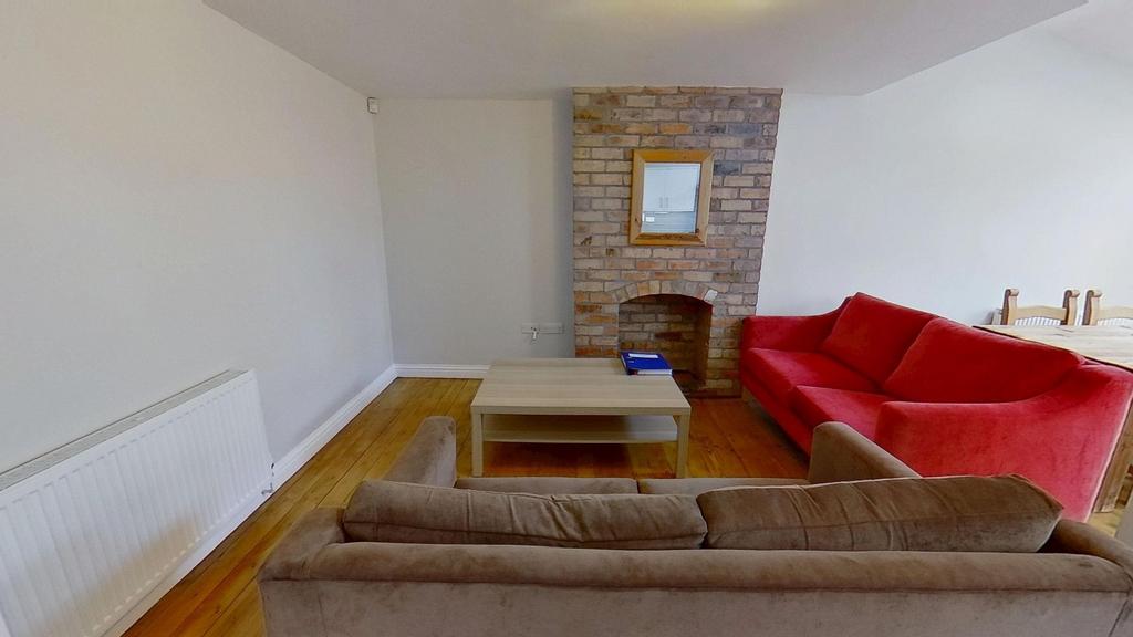 Bright, freshly painted living room with wooden...
