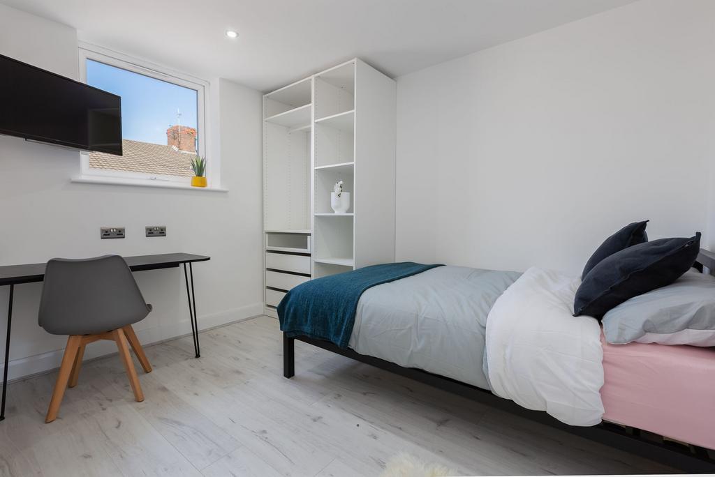 Bright and modern bedroom featuring a comfortab...