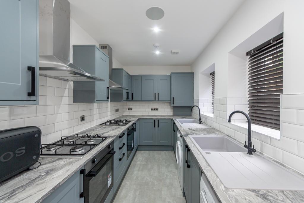 A modern, well-maintained kitchen featuring sle...