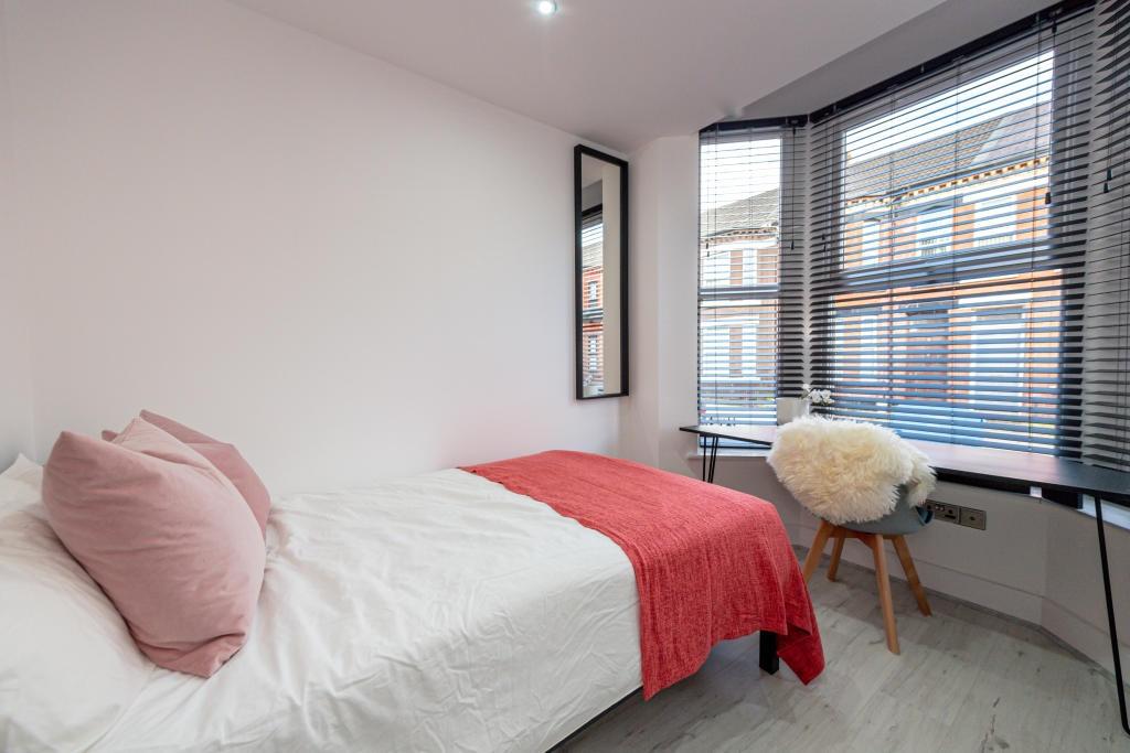A bright and inviting double bedroom featuring ...