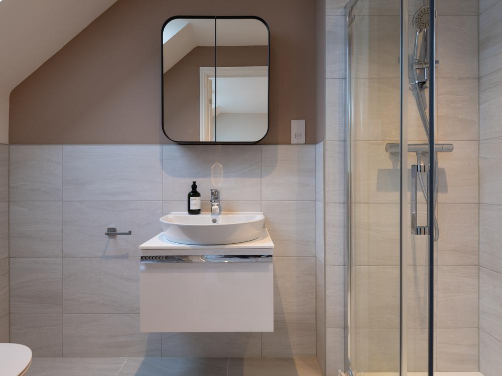 Main bedroom en-suite, large shower, sink with...
