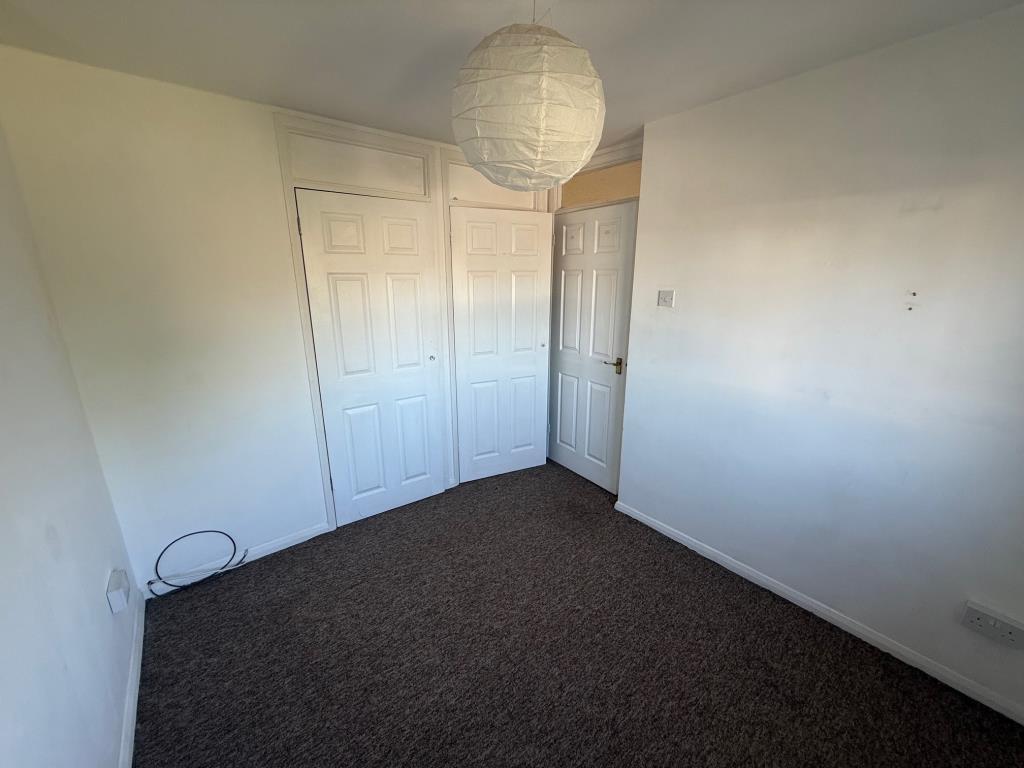 Second bedroom carpeted and painted white