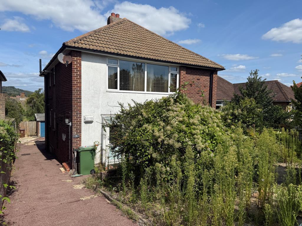 Front elevation with driveway and garden