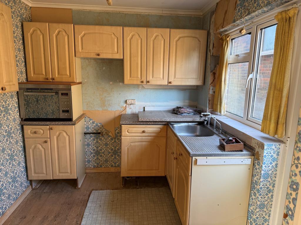 Kitchen with side window and fitted units