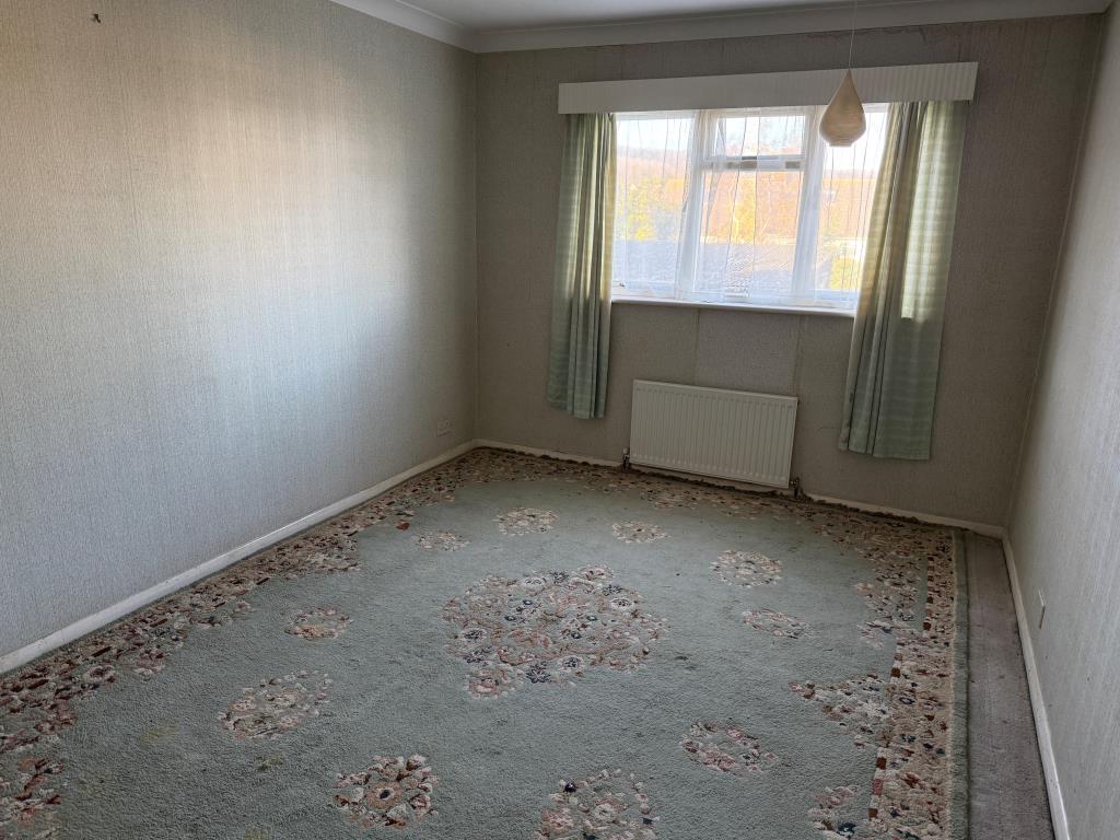 Main bedroom with window to rear