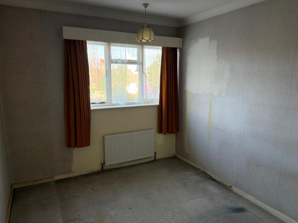 Second bedroom with window to rear