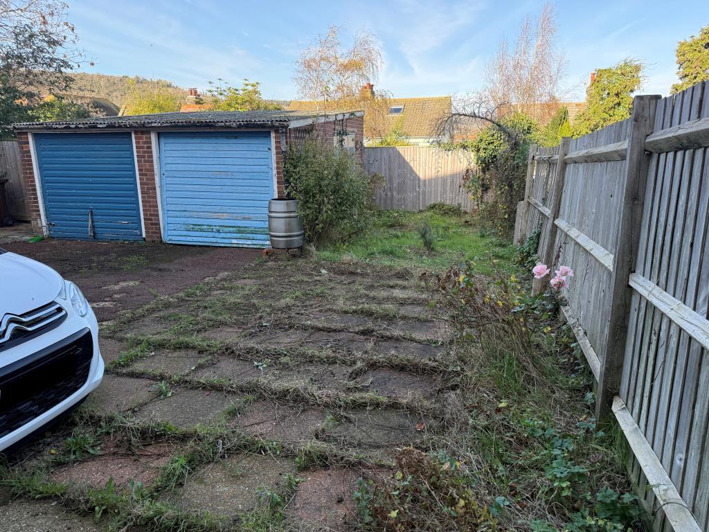 Side rear paved patio with parking area