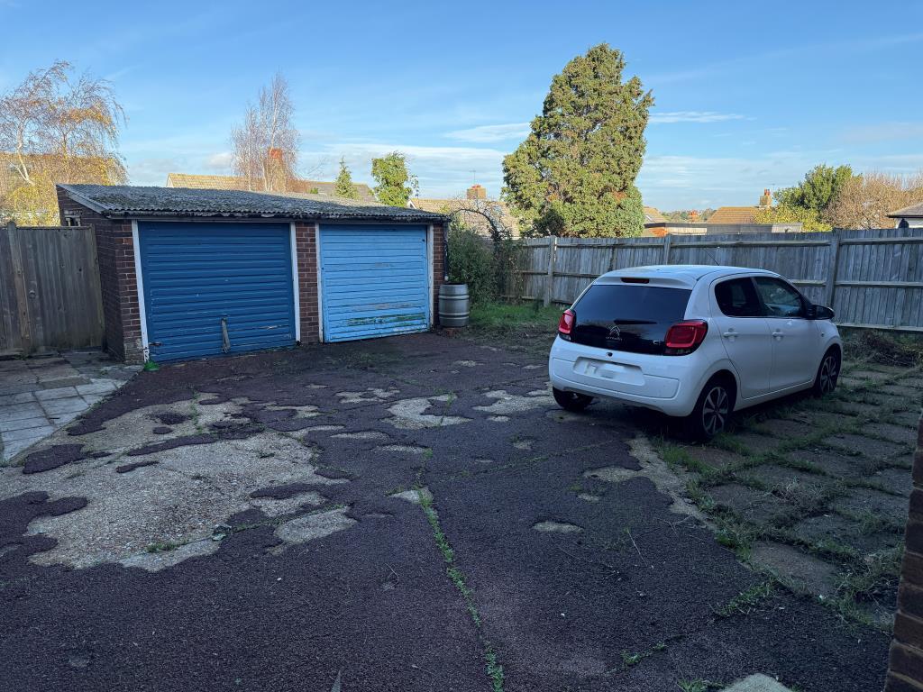 Garage with light blue door and driveway