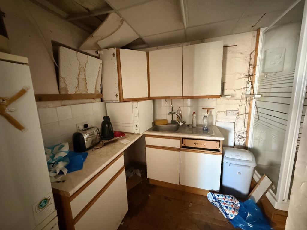 Small kitchen area with shower enclosure