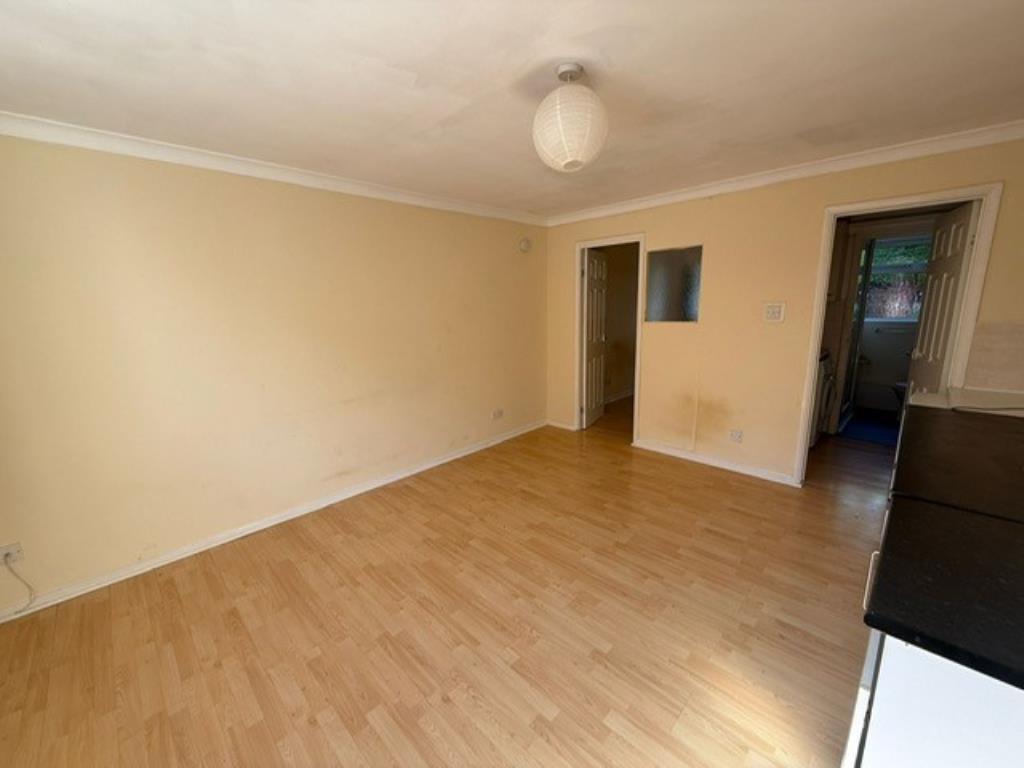 Living room view showing access to bedroom and kit