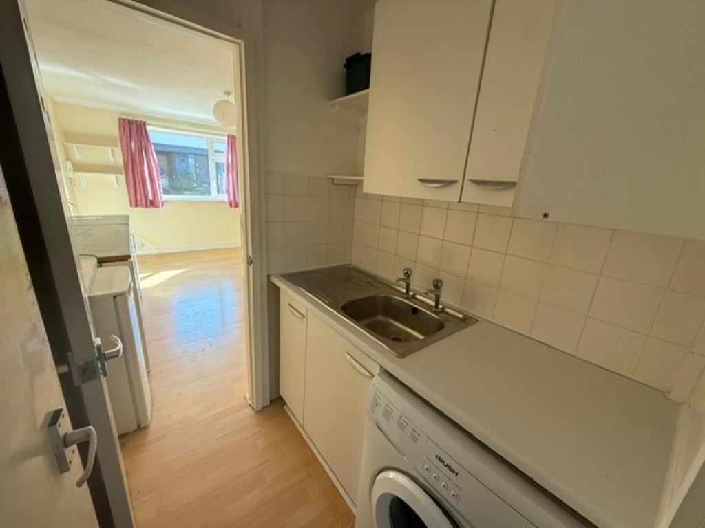Kitchenette view showing sink and doors leading to