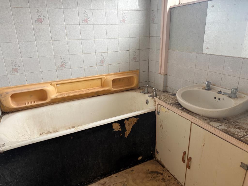 Bathroom with dated white suite
