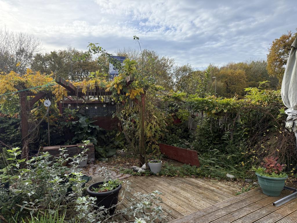 Garden with decking area and raised pond