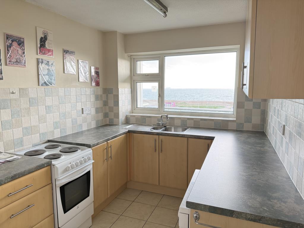 Fitted kitchen with view out to the beach