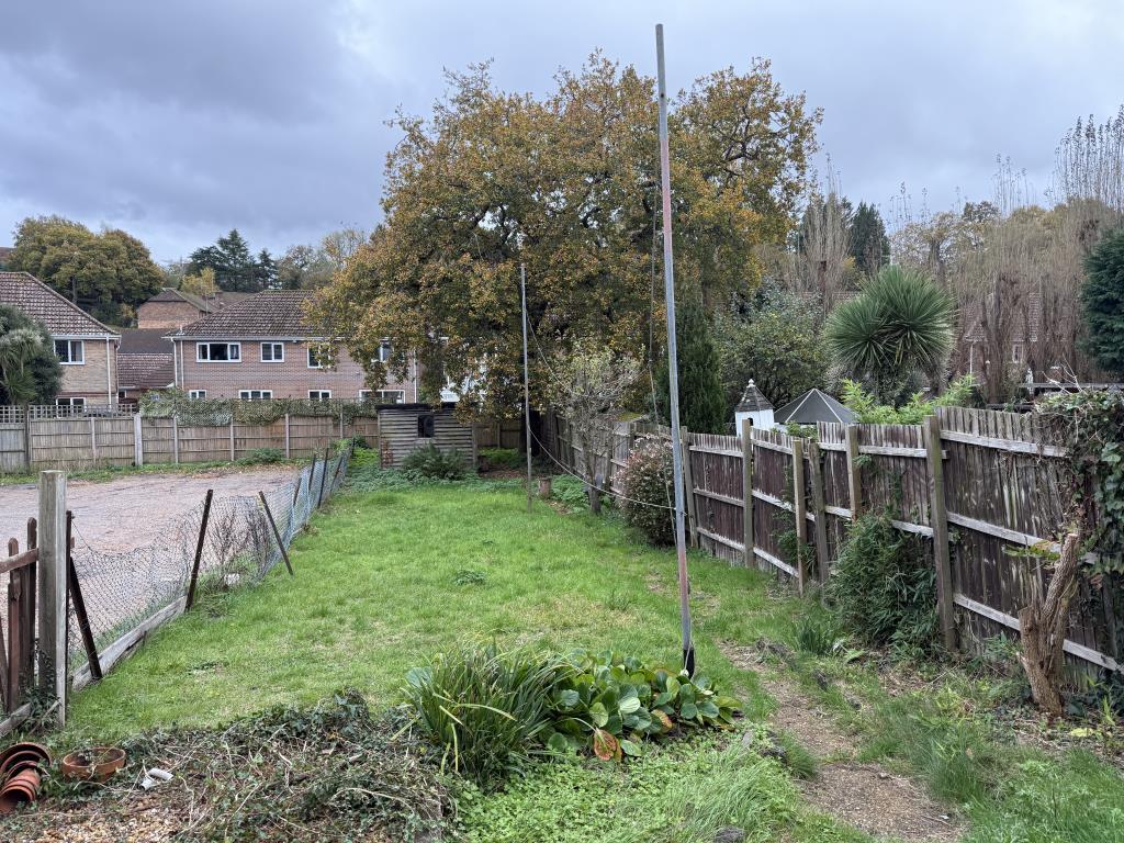 Garden with wooden shed and grass lawn