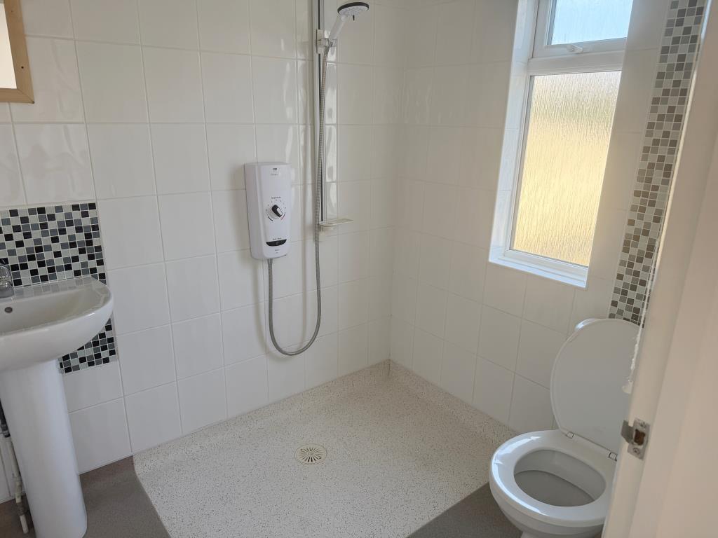 Walk in shower with white suite and WC