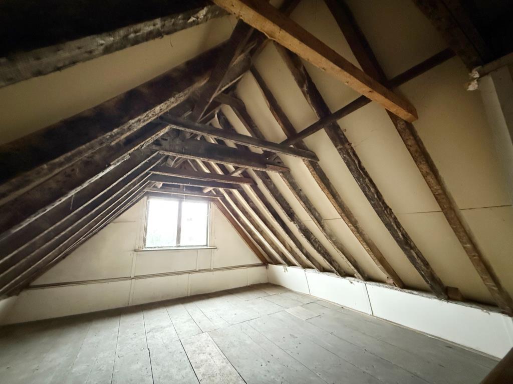 Attic level room two with exposed beams