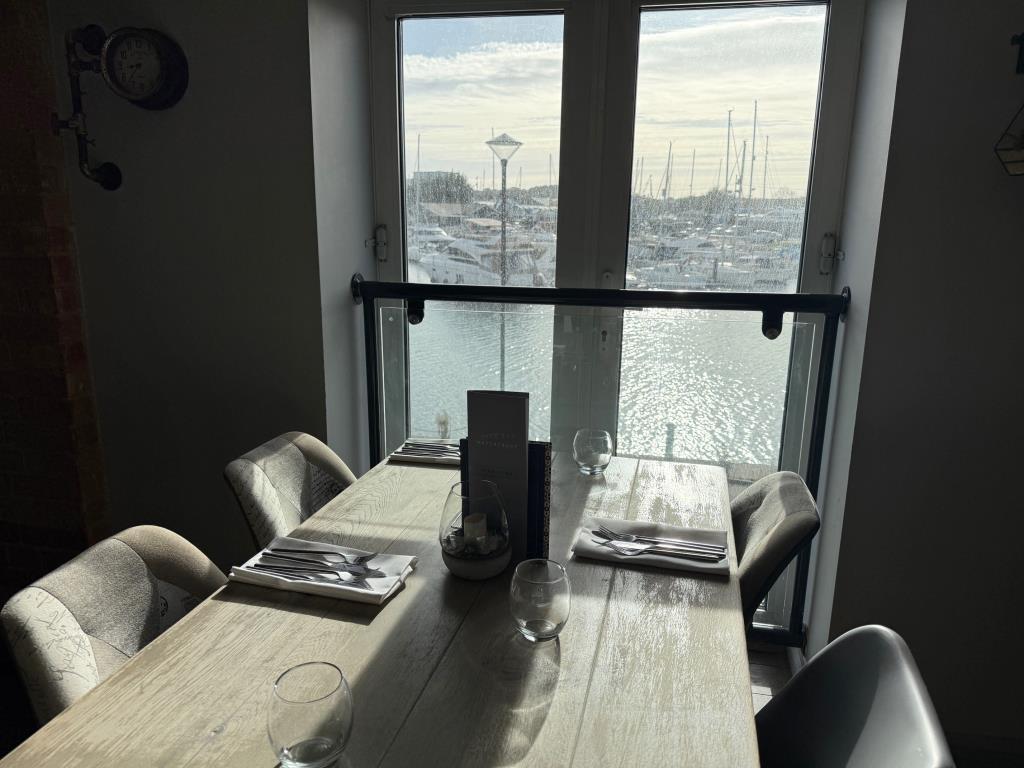First Floor Table in a view of the marina and boat