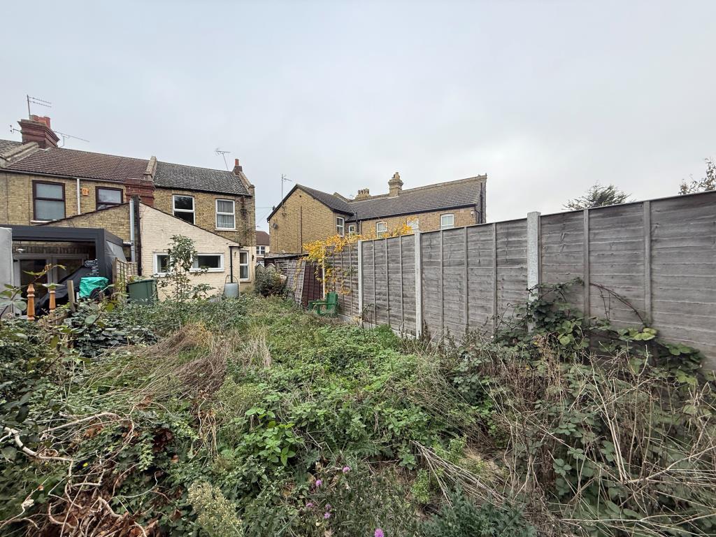 Shot of back of property with first garden view