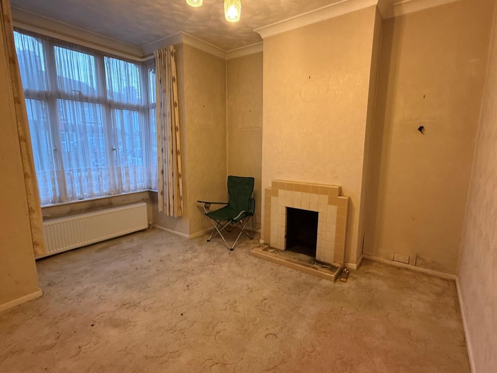 Carpeted lounge with fireplace and window