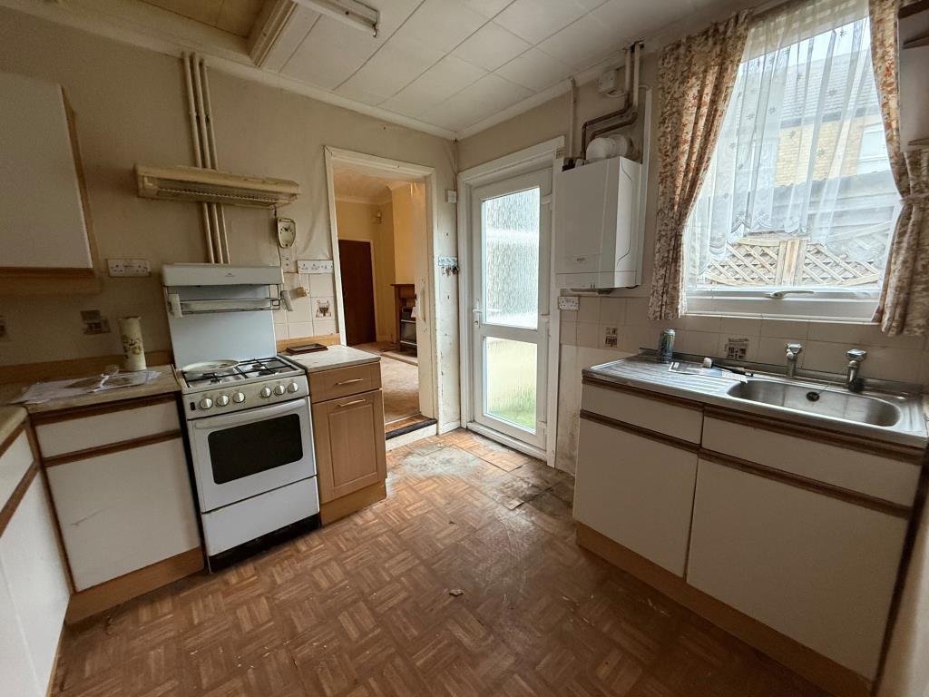 Kitchen with window and access into dining room an